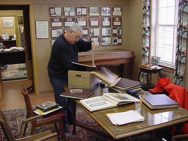 Photo of John Mills working with quarry records at the Dundas Historical Museum